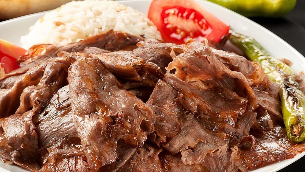 Doner Kebab (Gyro) · Thinly sliced lamb and beef marinated with chef's own secret blend of seasoning, cooked on a rotating spit served with rice.