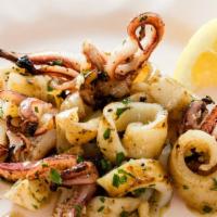 Grilled Calamari · Tender grilled calamari sauteed with tarragon, garlic and butter sauce served with our speci...