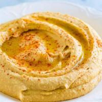 Hummus · Mashed chickpeas blended with fresh garlic, tahini and herbs.