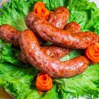 Homemade Sausage - Polish Style · a sausage ring with spices and herbs in rustic style. (chicken)