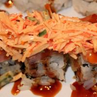 Johnny Roll · Shrimp tempura, avocado topped with tuna, salmon, and spicy crab salad.