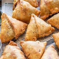 Samosa Chana Chat · Samosa spiced turnovers stuffed with potato nd peas is mixed with our signature with tamarin...
