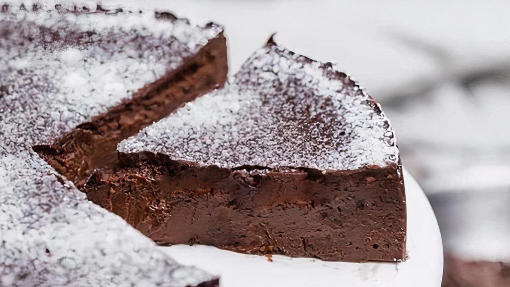 Flourless Chocolate Cake · This flourless cake, featuring both chocolate and cocoa, is rich, rich, RICH! A thick icing of chocolate ganache glaze takes it over the top.