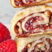 Raspberry Rugelach · The flaky and buttery hand-rolled dough is filled with raspberry preserve and pecans, making...