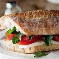 Caprese Sandwich · Mozzarella, tomato, pesto, balsamic, olive oil, arugula on a 7