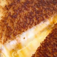 Grilled Cheese · American, Cheddar and  Manchego cheeses on sliced sourdough or your choice of bread.