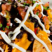 Nachos · Corn tortilla chips, nacho cheese, jalapeño, black beans, pico de gallo and sour cream.