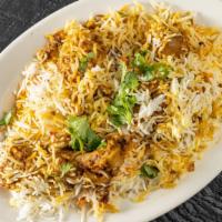 Chicken Biryani · Aromatic chicken cooked, spiced and steamed Dum style with Basmati rice.