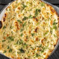 Garlic Naan · Minced Garlic and butter naan baked in clay oven.