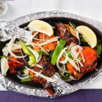 Tandoori Chicken · Chicken on the bone, marinated in spices and herbs grilled over a slow fire.