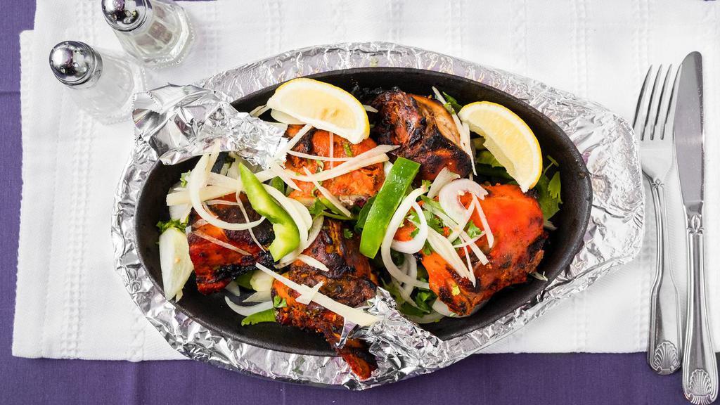 Tandoori Chicken · Chicken on the bone, marinated in spices and herbs grilled over a slow fire.