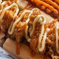 Fried Oyster Po'Boy · Bed of po'boy bread, fresh lettucce and tomato slices, 5 of freshly fried juicy oysters, ser...
