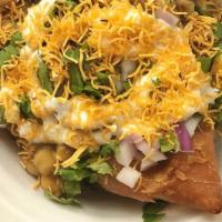 Samosa Chaat · 3 samosas combined to taste perfectly with choole, chutney, yogurt and topped with onions an...