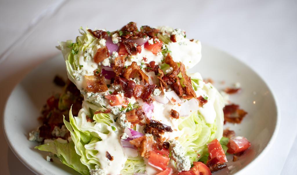 Little Gem Salad · Little gem lettuce wedge, bacon, tomato, red onion, crouton, blue cheese dressing.