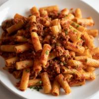Rigatoni Bolognese · Slow braised beef & pork meat sauce.