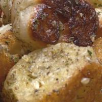 Garlic Knots (5) · Bread, topped with garlic & olive oil, herb seasoning, baked to perfection. Melts in your mo...
