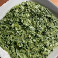 Creamed Spinach · Tender green spinach leaves made with onions and light seasoning in a creamy sauce.