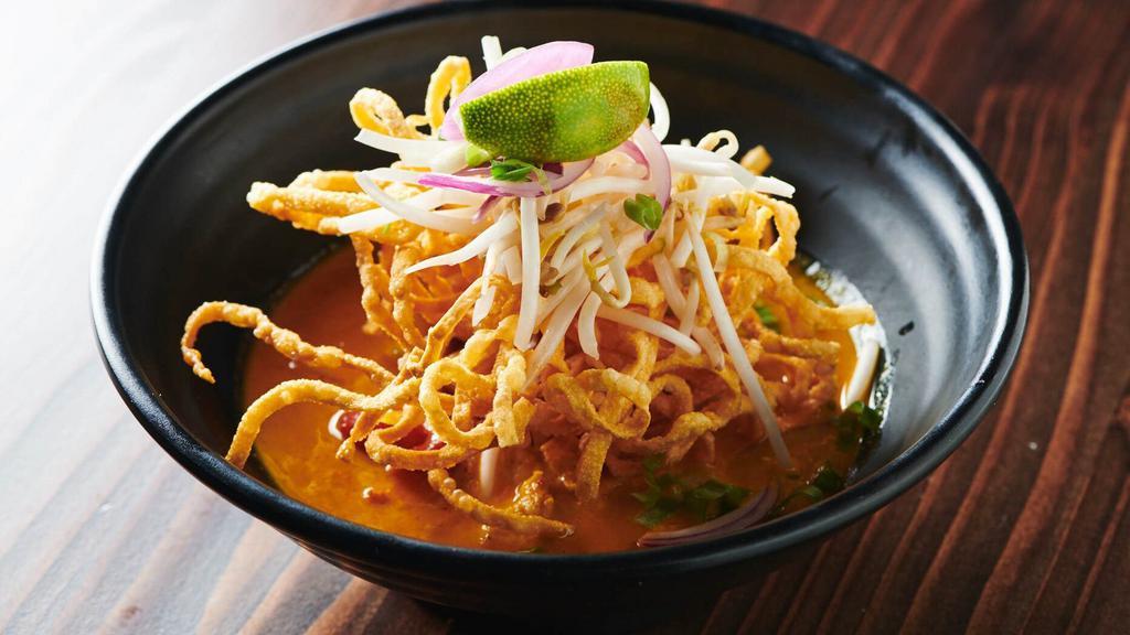 Kao Soi Noodle · Curry noodle. Northern-style noodle in yellow curry broth. Bell pepper, red onion. (Come with crispy noodle, red onion, cilantro, beansprout and lime on the side.)