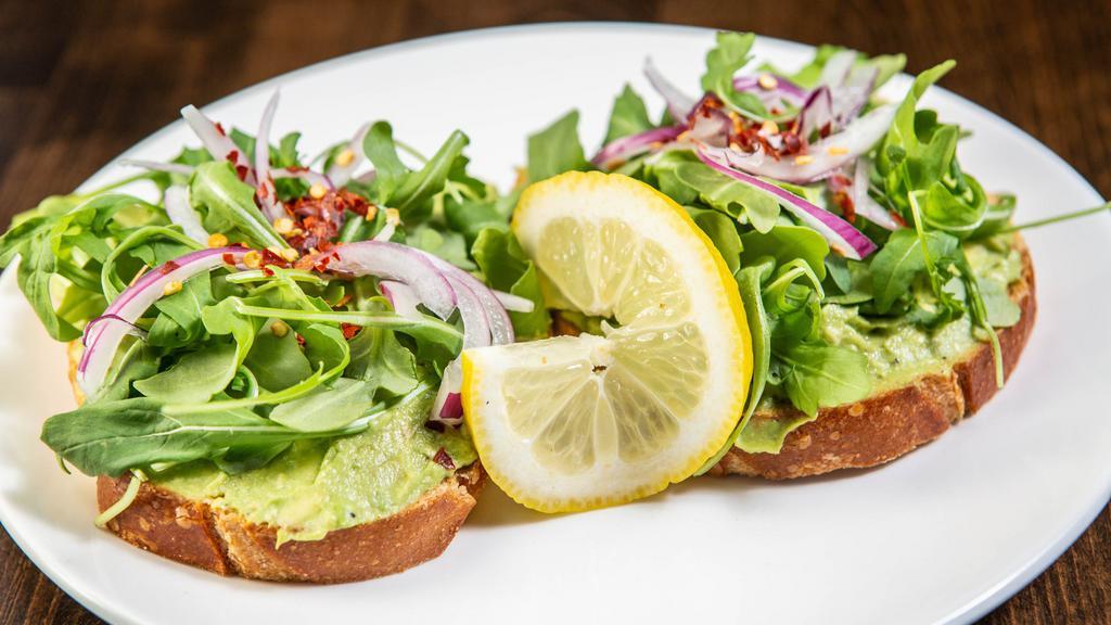 Avocado Toast · Hand smashed fresh avocado, spring greens, red onion, red pepper flakes, fresh lemon juice and extra virgin olive oil drizzled on top of Pullman health bread.