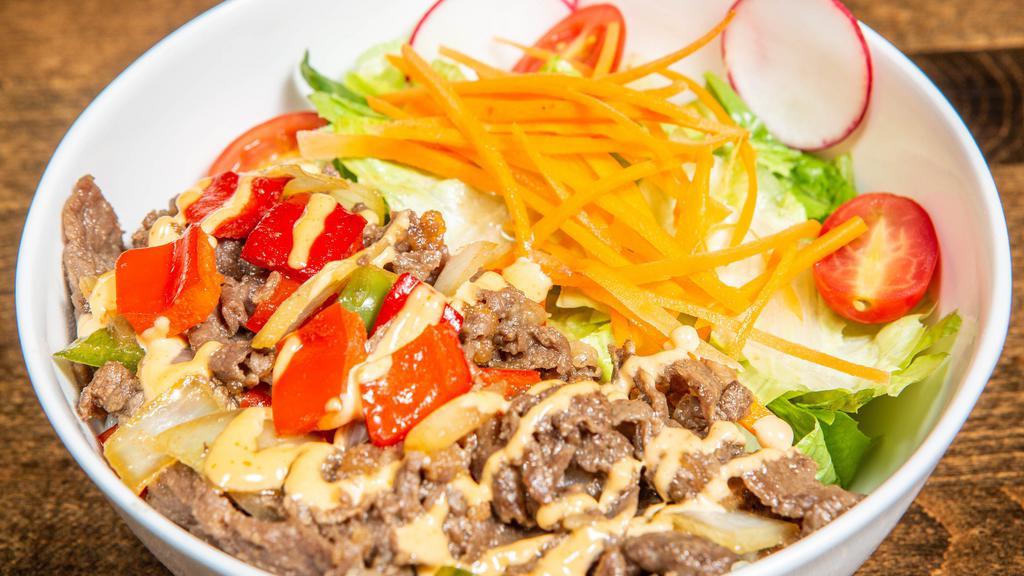 Bulgogi Rice Bowl · In house marinated sliced ribeye steak and vegetables (sauteed bell peppers, & onions... then mixed with cherry tomatoes, carrots, romaine and red radish) served over white rice with spicy mayo on top of your selected meat.