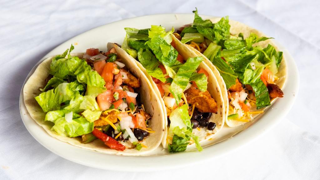 Three Tacos · Filled with mixed greens, carrot, Pico de Gallo, cheese, and black beans.