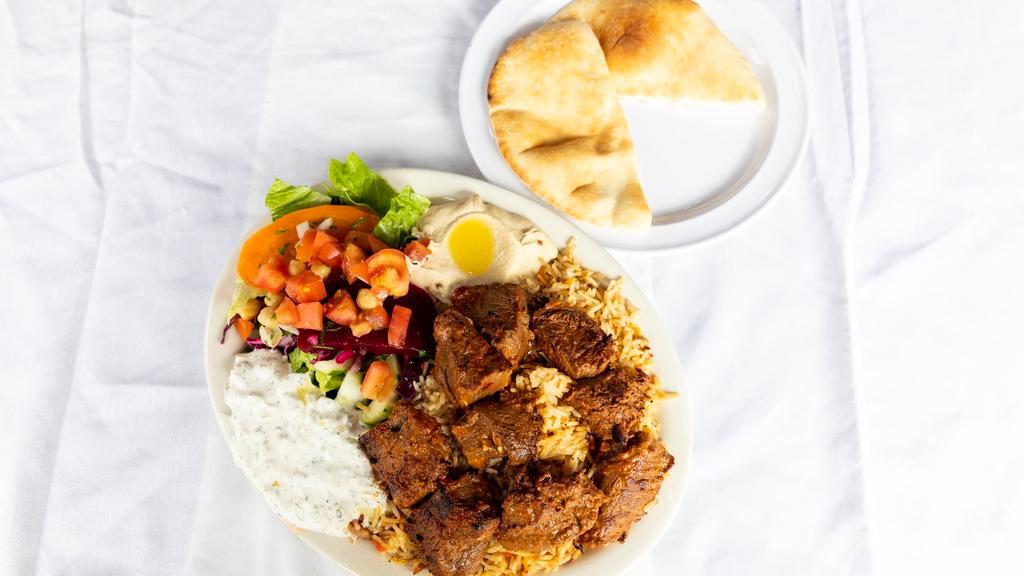 Kafta Kebab Platter · Charcoal grilled ground beef and lamb, parsley, onion, and spices. Served with rice and salad and either hummus.