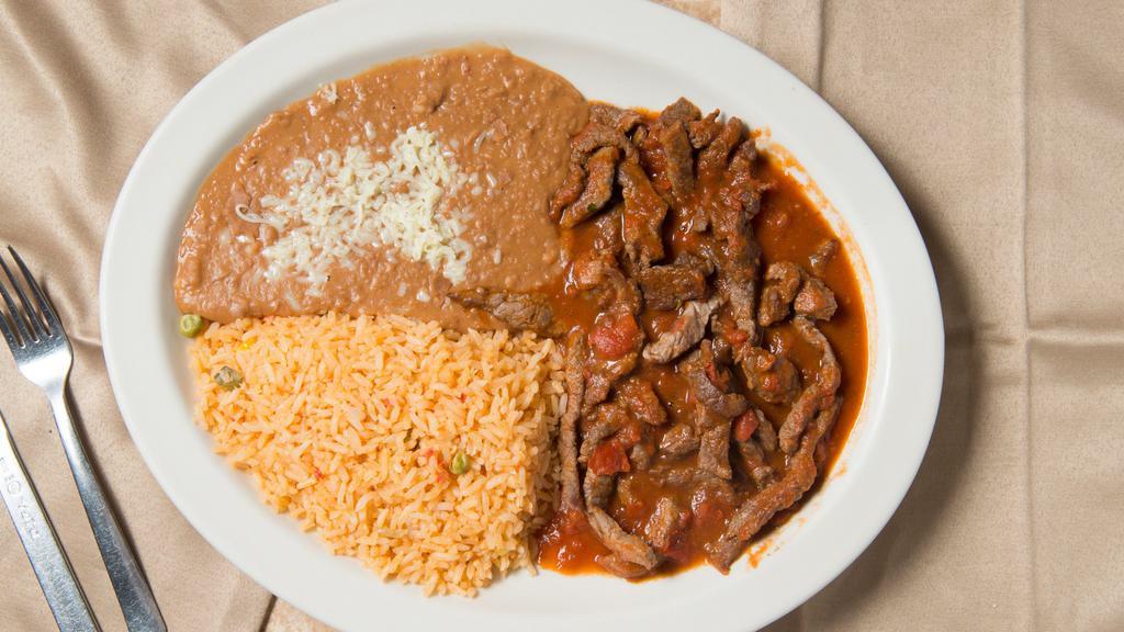 Chile Colorado · Hot. Grilled steak with red hot sauce served with tortillas, guacamole salad, rice and beans.