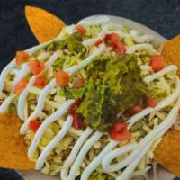 Nachos Supreme · Served with your choice of meat, lettuce, tomato, sour cream, & guacamole
