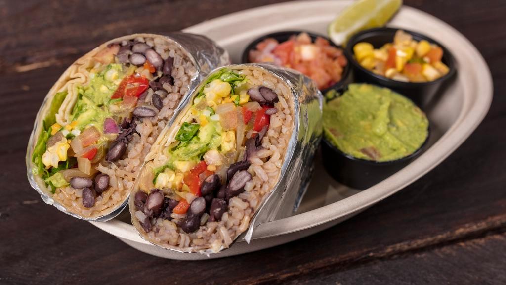 Vegetarian Burrito · Homemade corn salad, traditional guacamole, roasted peppers, and onions. Served with shredded Romaine lettuce, beans, corn salad, shredded cheese, and cilantro lime vinaigrette.