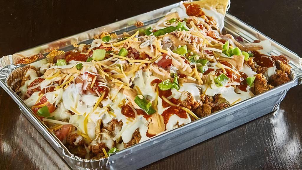 Chorizo Nachos · Spicy pork sausage with signature blended spices. Loaded with beans, shredded cheese, and sour cream. Spicy.