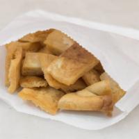 Pita Crisps · Fried pieces of pita bread for a crispy side snack.