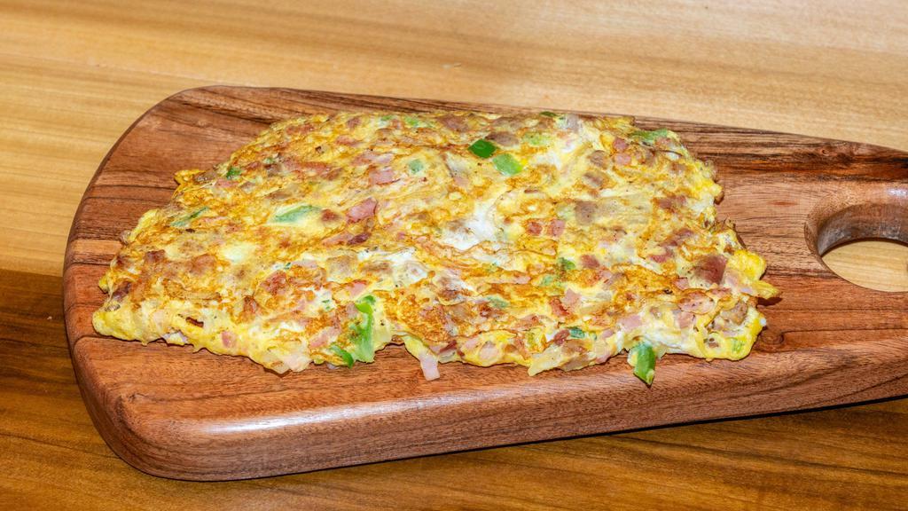 Toasty Signature Omelette · Sausage, crispy bacon, ham, Muenster cheese, onions, peppers.
