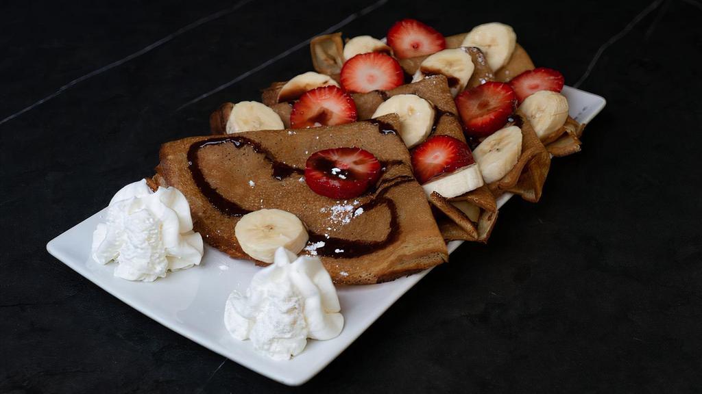 Crepes · Freshly sliced banana, strawberries, topped with Nutella, powdered sugar and whipped cream.