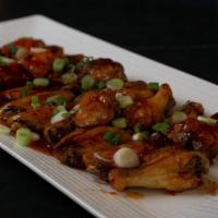 Spicy Volcano · Wings covered in house volcano sauce topped with scallion served with a side of celery, carr...