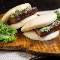 Pork Belly Bao Bun (2)  · Soy sauce braised pork belly, pickled sour cabbage, crushed peanuts, and cilantro wrapped in...