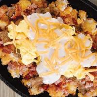 The Big Country · Pork sausage, bacon, ham, American cheese and cream gravy with two eggs served over smashed ...