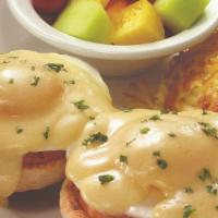 Classic Eggs Benedict · The tried and true favorite. Two basted eggs, grilled ham and creamy hollandaise a top an En...