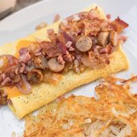 Meat & Potatoes Omelet · Pork sausage links, applewood smoked bacon, smoked ham, caramelized onions, and cheddar atop...
