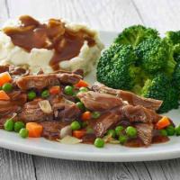 Classic Pot Roast · Tender chunks of braised beef, sweet green peas, tender carrots, onions and a hearty beef gr...