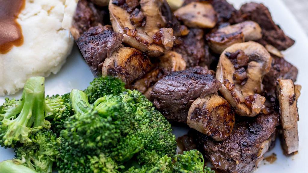 Steak Medallions With Mushrooms · Tender USDA steak medallions with crimini mushrooms and onions, topped with garlic butter. Served with 2 sides.