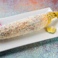 Elote Asado · Grilled corn on the cob, Mexican mayo crumbled cotija cheese and Chile piquin.