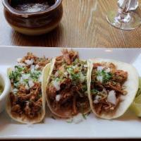 De Carnitas · Dark beer and Coca Cola marinated roasted berkshire pork butt, topped with onions, cilantro....