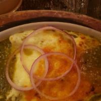 Enchiladas Suizas · Corn tortilla simmered, rolled and filled with shredded chicken topped with creamy tomatillo...