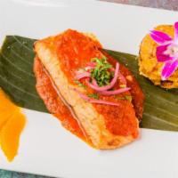 Salmon Maya · Oven roasted salmon filet over banana leaf, topped with bitter orange achiote sauce and serv...