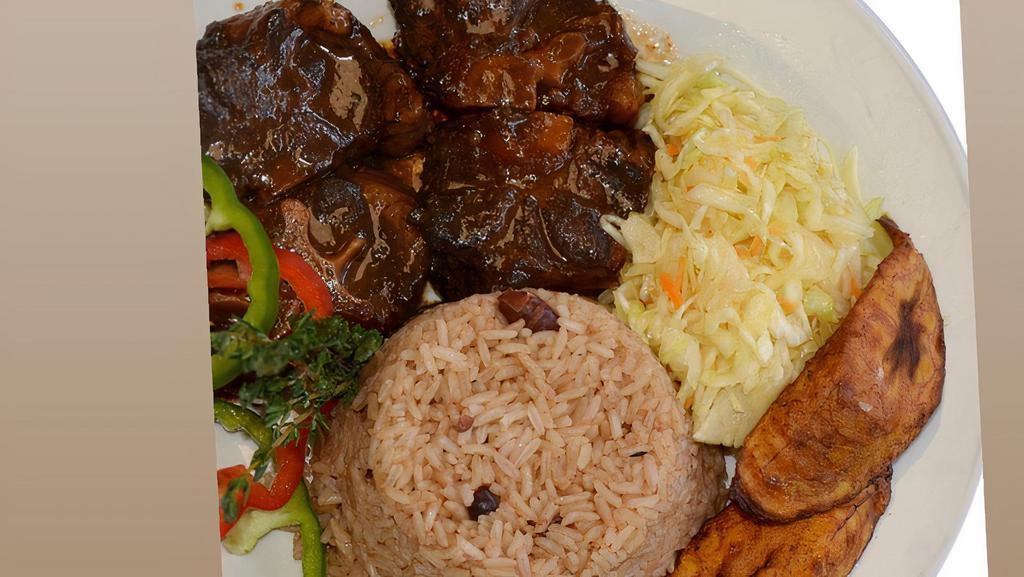 Oxtail · Served with white rice or rice and peas! Also your choice of steam vegetables or fresh salad