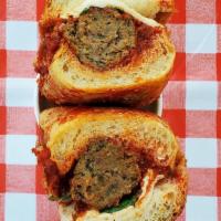 Meatball Parm Hero · Happy Valley beef meatballs, fresh mozz, tomato sauce, basil on a housemade seeded hero roll.
