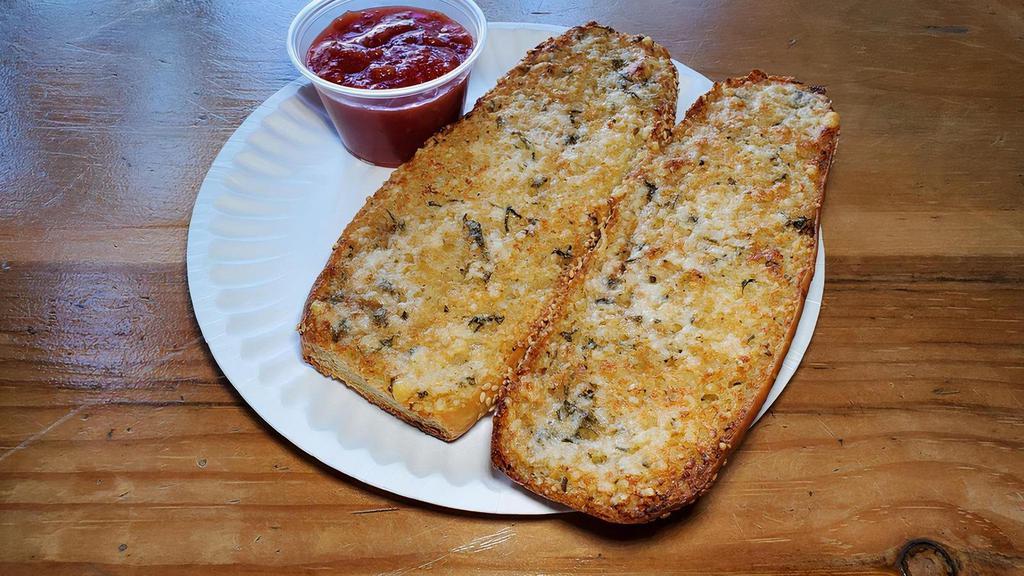 Garlic Bread · Housemade seeded bread topped and baked with garlic butter and pecorino. Served with a side of warm tomato sauce.