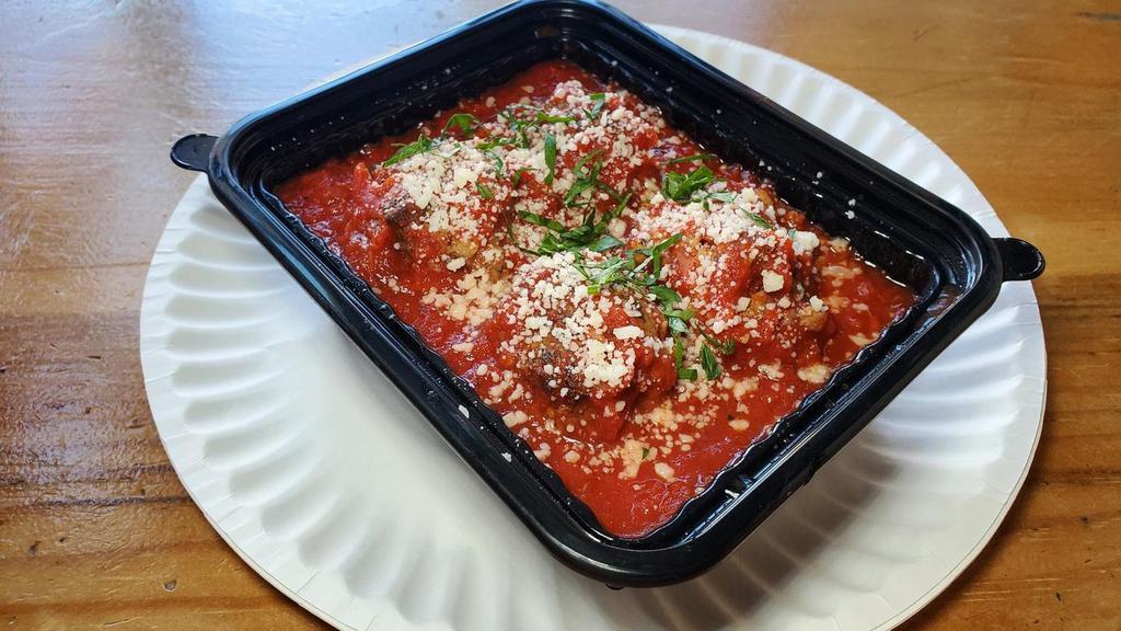Meatballs · Three Happy Valley Beef meatballs in tomato sauce garnished with pecorino and parsley.