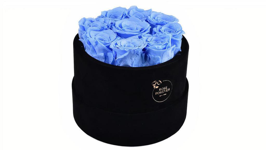 Forever Roses Blue Round Box · Each forever rose box  is handcrafted.
All forever roses last a year.  
This blue rose bouquet has 9 gorgeous preserved roses that last for a year. 
To make each rose arrangement look fresh and elegant the best rose preservatives you can find on the market are used, and carefully arranged  in black, vegan velvet, Parisian hat boxes.
Quantity: 9 red roses
5.5Hx7Wx7L