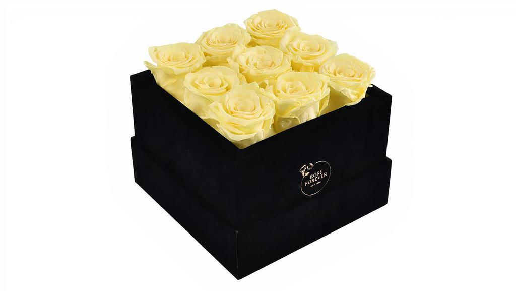 Forever Roses Yellow Square Box · Each forever rose box is handcrafted.
All forever roses last a year.  
This yellow rose bouquet has 9 gorgeous preserved roses that last for a year. 

To make each rose arrangement look fresh and elegant the best rose preservatives you can find on the market are used, and carefully arranged  in black, vegan velvet, Parisian hat boxes.

Quantity: 9 yellow roses
5.5Hx7Rd